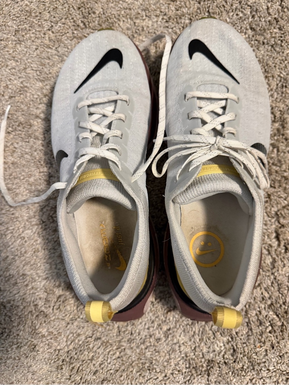 Nike White Running Shoes with Black Swoosh and Yellow Accents